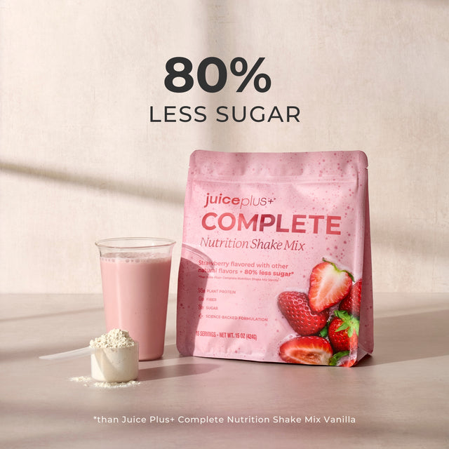 Juice Plus+ Complete Nutrition Shake Mix package with a glass of shake and strawberries on a light background